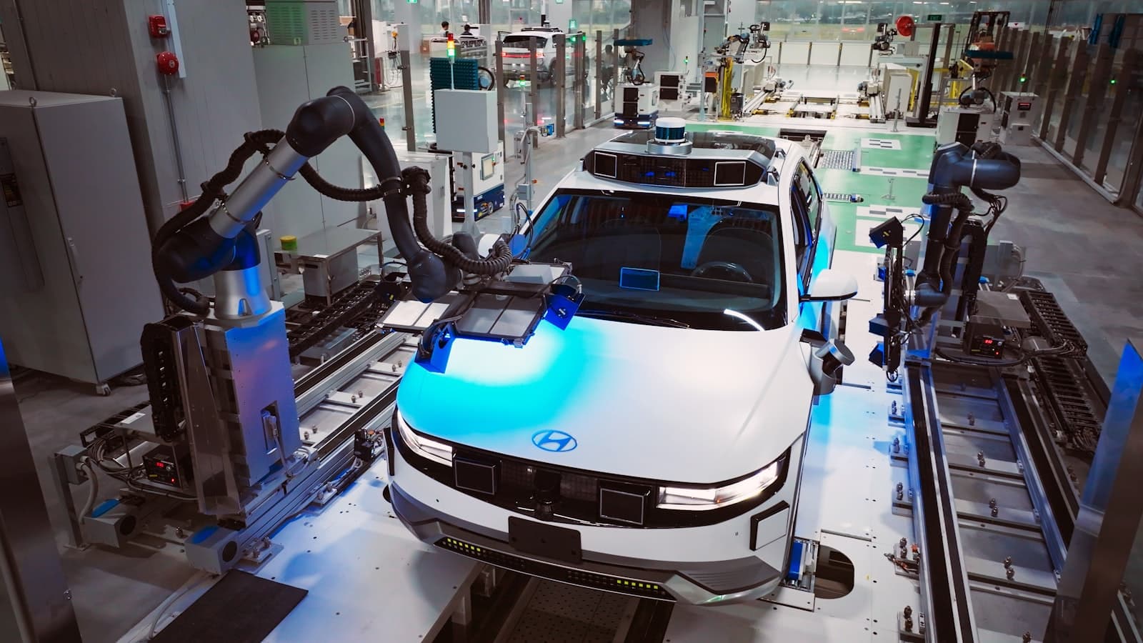 Robot arms working on a Hyundai IONIQ 5 on an assembly line
